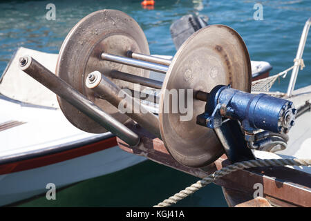Bow winch for fishing net on small wooden boat moored in Ayia Napa, Cyprus  island Stock Photo - Alamy