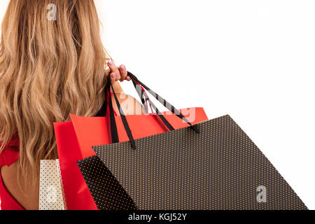 Back view of woman carrying shopping bags on shoulder isolated on white background with text area Stock Photo