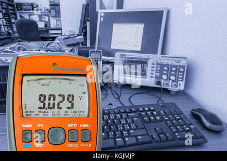 Detail of digital multimeter on workplace. Measuring equipment in the electrotechnical laboratory. Stock Photo