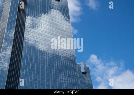 Cloud reflecting on tall glass building representing business cloud computing. Stock Photo