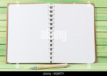 Open blank notebook with pen on wooden board as diary or journal concept Stock Photo