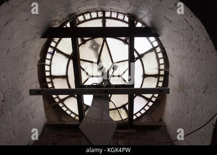 Interior view of a small traditional Victorian Church clock shwoing the face and hand workings, UK Stock Photo