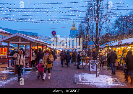 KIEV, UKRAINE - JANUARY 4, 2017:  Tourists and locals visit the Christmas Market in Vladimirskaya street, the stalls offer tasty Ukrainian cuisine and Stock Photo