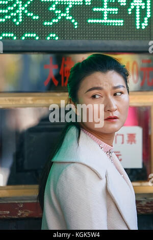 Zhangye,China - October 20,2017: Chinese woman catches tickets at a box office on October 20, China. Stock Photo