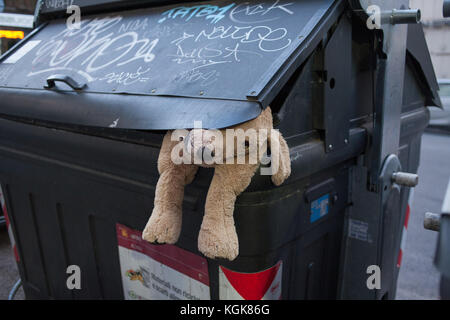 Abandoned teddy bear in the trash can. The symbol of leaving childhood ...