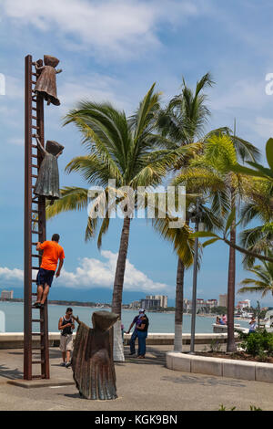 PUERTO VALLARTA, MEXICO - SEPTEMBER 6, 2015: Unidentified people by Searching for Reason statue at Puerto Vallarta, Mexico. Sculpure was made by Sergi Stock Photo