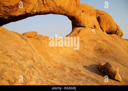 Big granite rock arch at sunrise around Spitzkoppe in Namibia Stock Photo