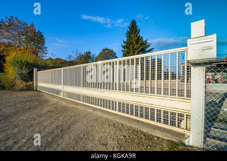 Long, sliding metal farm gate - France Stock Photo - Alamy