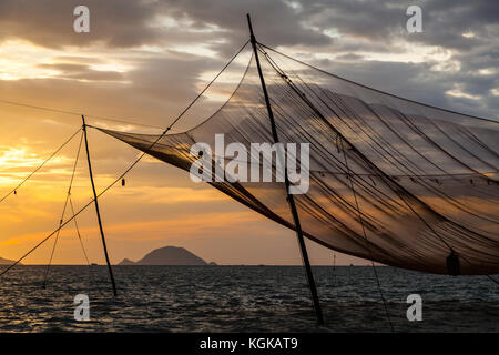 Traditional hanging fishing net in the sea, at the entrance to Thu Bon River, Hoi An, Vietnam Stock Photo