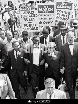 Reverend Dr. Martin Luther King, Jr, left, and other civil rights leaders hold hands as they lead a crowd of hundreds of thousands at the March on Washington for Jobs and Freedom, Washington DC, August 28, 1963. Also pictured is Rabbi Joachim Prinz, right center. Credit: Arnie Sachs / CNP /MediaPunch Stock Photo