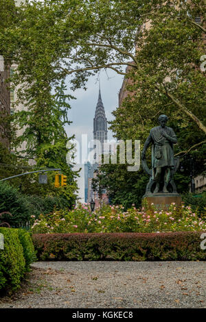 A statue of Edwin Booth as Hamlet in Gramercy Park (a private park in New York City) with the Chrysler building in the background. Stock Photo