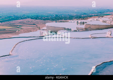 Turquoise color view of Pamukkale (Cotton Castle) is popular with Travertine pools and terraces  where people love to visit in Pamukkale, Turkey. Stock Photo