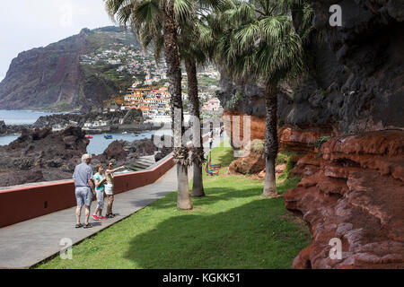 Tourists on a path approaching Camara de Lobos, a village near Funchal in Madeira, where Winston Churchill used to visit and paint Stock Photo