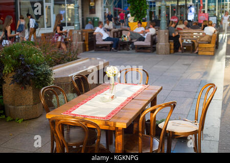 Empty table at restaurant with beautiful bouquet of chamomile. Croatia, Zagreb Stock Photo