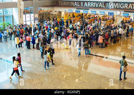 SINGAPORE - JAN 13, 2017: People waiting in queue at arrival immigration of Changi airport. Changi International Airport serves more than 100 airlines Stock Photo