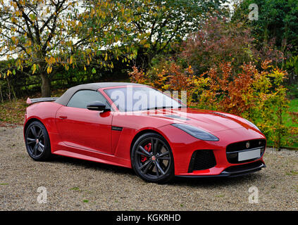 A red Jaguar F-Type SVR sports car in a country driveway. Stock Photo
