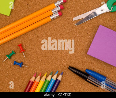 A Background of School Supplies on a Cork Board Stock Photo