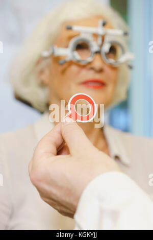 Cropped hand of doctor holding medical equipment while examining patient at clinic Stock Photo