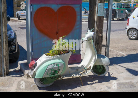 Old Vespa scooter decorated with plants, Parikia, Paros island, Cyclades, Aegean, Greece Stock Photo