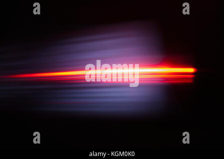 Close-up of abstract red light trail against black background Stock Photo