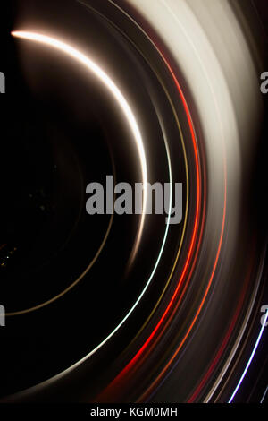 Directly above full frame shot of abstract light trails against black background Stock Photo