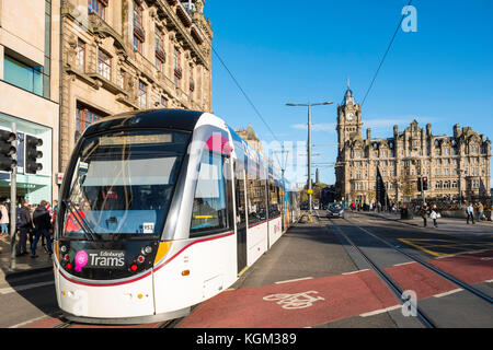 View along Princes street with tram and Balmoral Hotel visible in Edinburgh , Scotland, United Kingdom. Stock Photo