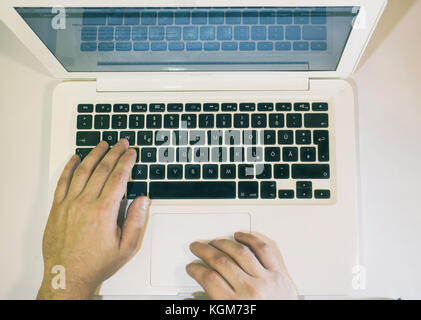 Using an Apple Laptop Computer top view, Vienna Austria 9.11.2017 Stock Photo