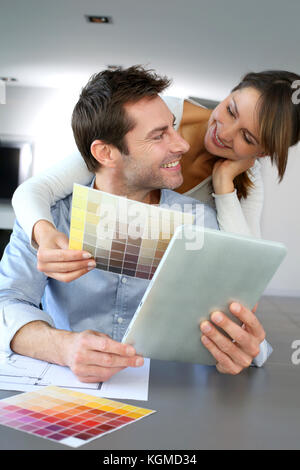 Couple choosing paint colour for their new home Stock Photo
