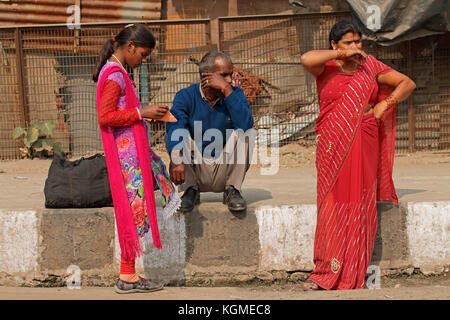 Delhi, India - November 24, 2015: Indian man and women in colorful traditional dresses in the populated city of Deli Stock Photo