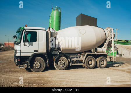 White concrete mixer vehicle on the construction site. Construction aggregate dumps Stock Photo