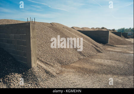 Construction aggregate and gravel dumps at concrete production plant. Side view Stock Photo
