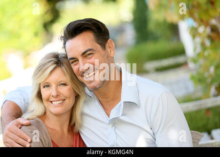 Portrait of loving mature couple relaxing on bench Stock Photo