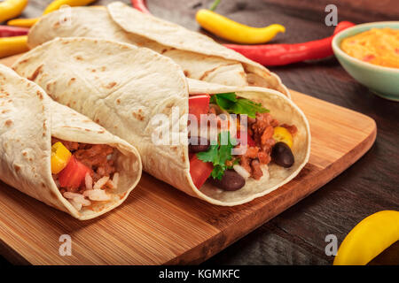 Closeup of Mexican burritos with beef, rice, and chili peppers Stock Photo