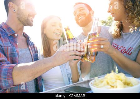 Group of friends cheering with beers Stock Photo