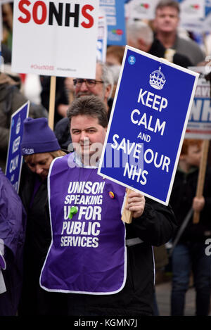 Keep calm and save our nhs placard during Our NHS protest demonstration rally march against alleged UK Tory Conservative cuts and privatisation plans Stock Photo