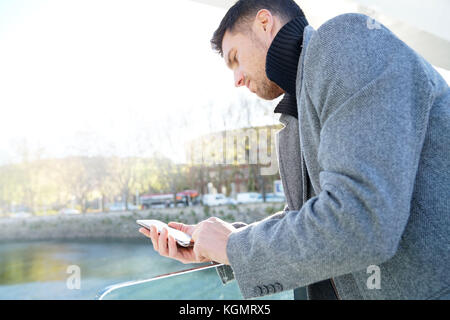 Handsome businessman talking on phone outside Stock Photo