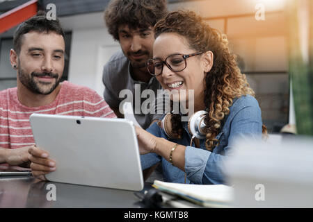 Young entrepreneurs working on digital tablet Stock Photo