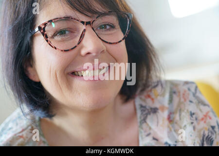 Portrait of cheerful mature woman with eyeglasses Stock Photo
