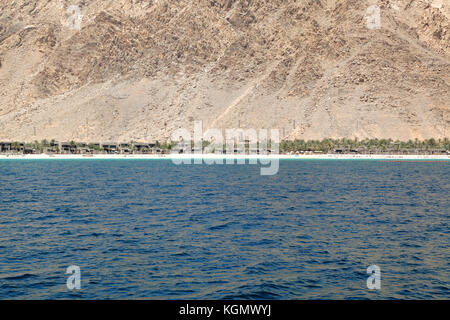 Holiday resort nestling at the base of the Musandam Mountain range, Sultanate of Oman Stock Photo