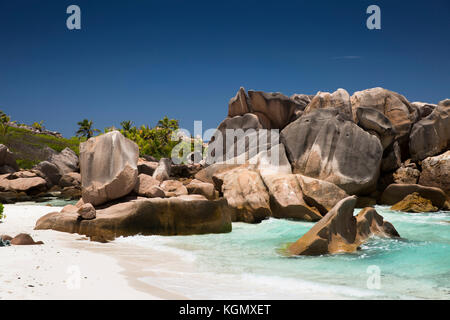 The Seychelles, La Digue, Anse Cocos, beach, eroded granite rock formation in sea Stock Photo