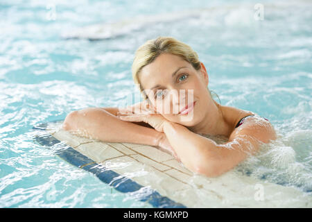 Beautiful blond woman relaxing in thalassotherapy thermal water Stock Photo