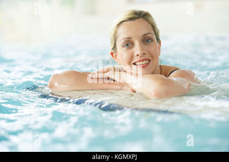 Beautiful blond woman relaxing in thalassotherapy thermal water Stock Photo