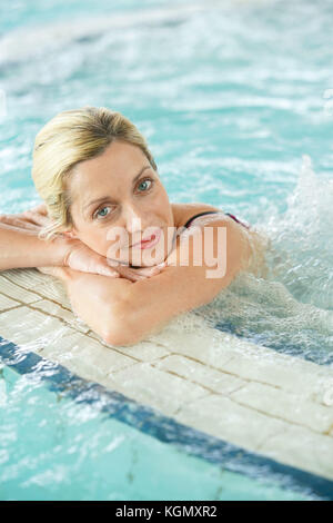 Beautiful blond woman relaxing in thalassotherapy thermal water Stock Photo