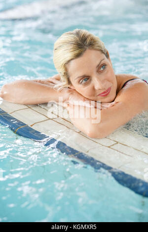 Beautiful blond woman relaxing in thalassotherapy thermal water Stock Photo