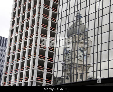 The elegant tower of the Gare de Lyon in Paris, France, is reflected in a tall less distinguished modern building Stock Photo