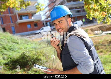 Foreman on site using walkie talkie Stock Photo
