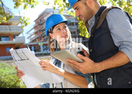 Construction engineers working together on site Stock Photo