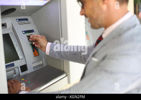 Man Withdrawing Money From ATM Machine Stock Photo - Alamy