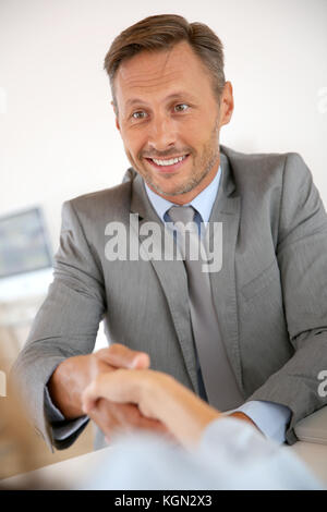 Man shaking hand to job applicant after interview Stock Photo