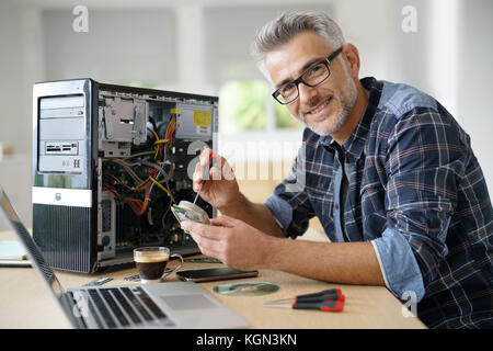 Technician repairing computer hardware Stock Photo